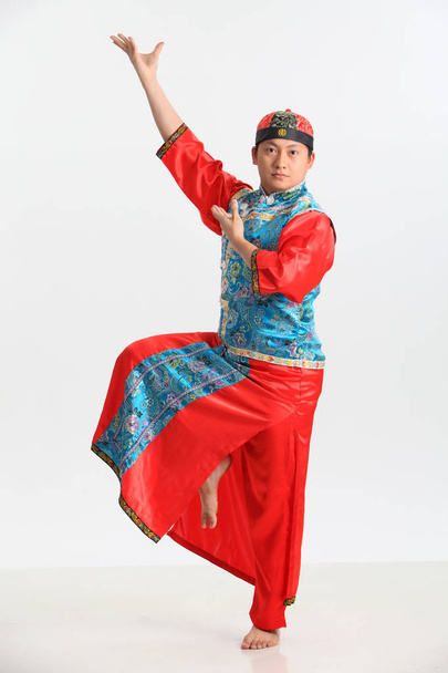 chinese man in traditional costume posing in studio  - 写真・画像