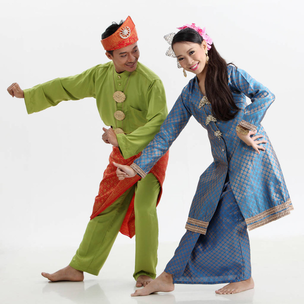  malay couple in traditional costumes posing in studio - Фото, зображення