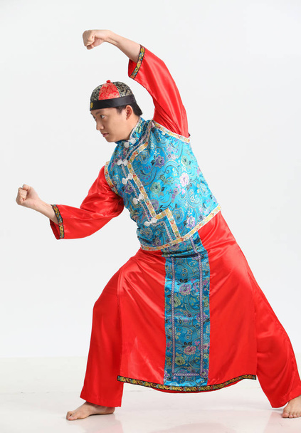 chinese man in traditional costume posing in studio  - 写真・画像