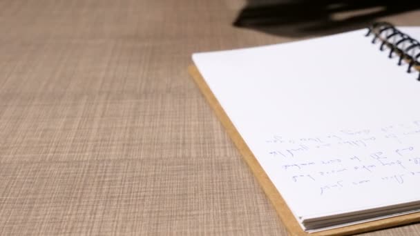 Close up on man hand writing in a notebook - Materiał filmowy, wideo