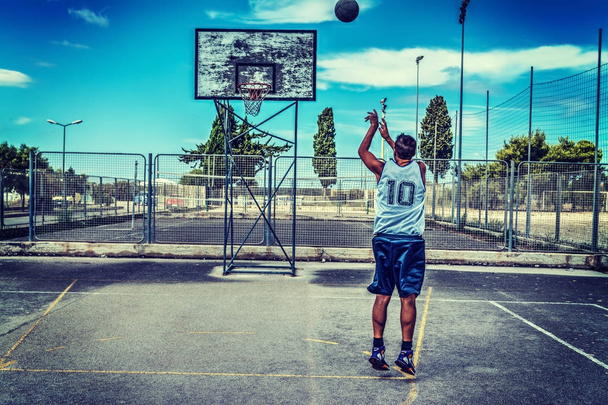 Jump shot in een basketbalveld - Foto, afbeelding
