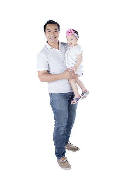 Young father holding his daughter on studio - Foto, Bild