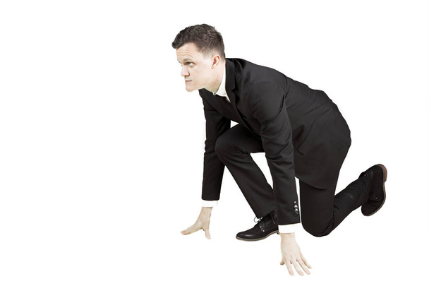 European businessman kneeling on studio - Foto, Imagen