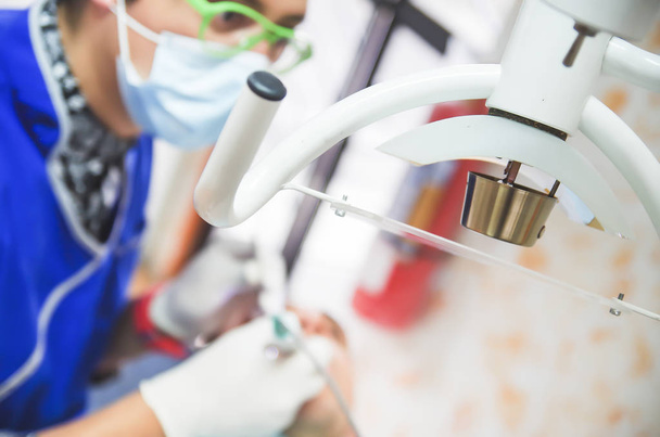 Close up of selective focus of Dentists medical equipment with a dentist working in a blurred background - Foto, Imagen