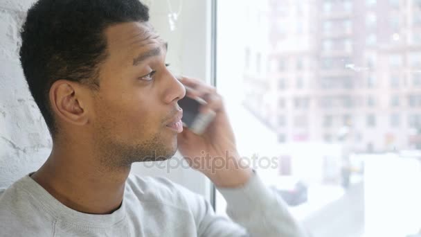 Zblízka Afro-American člověka mluví se zákazníkem na Smartphone - Záběry, video