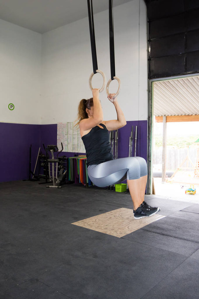 Vrouw bij grensoverschrijdende opleiding Fitness Gym - Foto, afbeelding