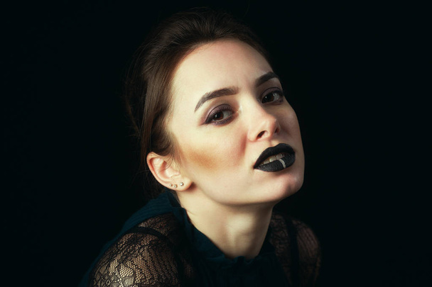 Beauty and makeup. Closeup of a beautiful young woman . Portrait of sexy young female model with professional makeup on dark background - 写真・画像
