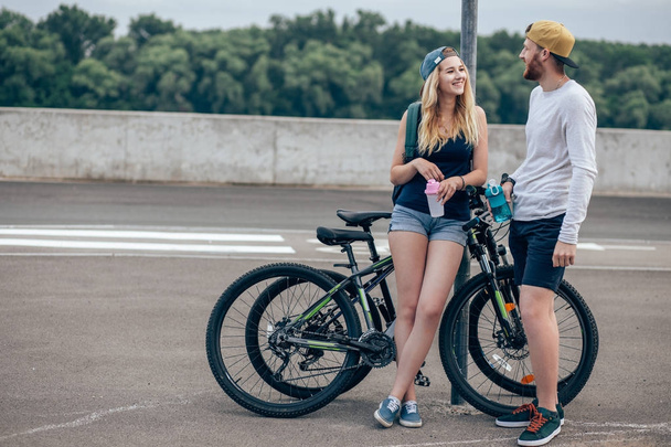 Young hipster couple holding hands standing on road - Fotografie, Obrázek