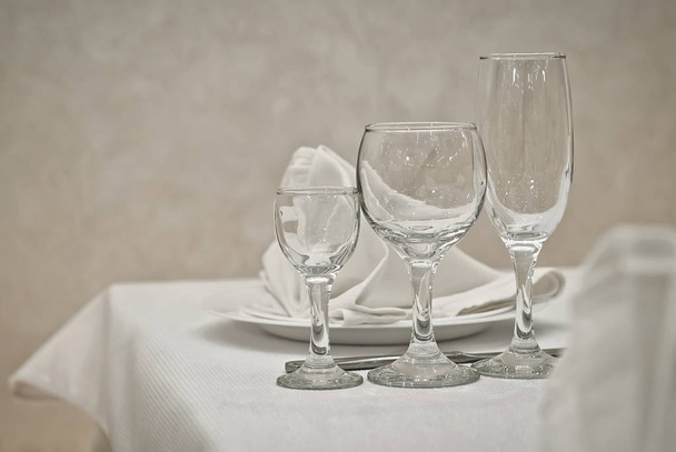 Glass dishes on a table on a white tablecloth - Φωτογραφία, εικόνα