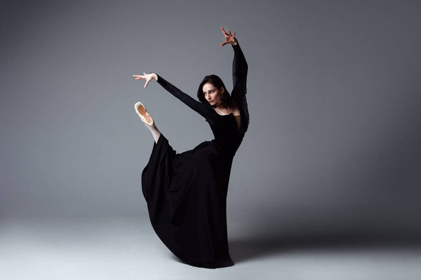 Slim ballerina in a black long dress - Zdjęcie, obraz