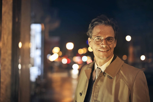 Portrait of a elegant man on a city road at night  - Photo, Image