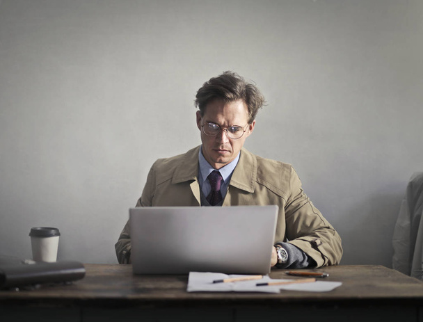 Portrait of an elegant man using a laptop  - Photo, Image