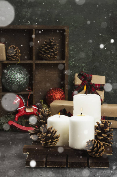 Burning candles and Christmas attributes on a dark background. S - Photo, image