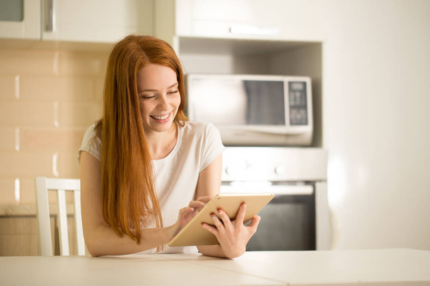 happy smiling woman sitting with digital tablet - Foto, Imagem
