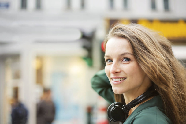Portrait of a young woman outdoor with headphones  - Fotoğraf, Görsel