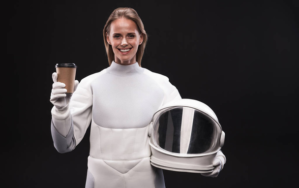Happy spacewoman is smiling and drinking espresso - Фото, изображение