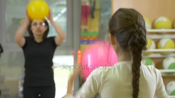 gymnastics with a childrens instructor in physical education. occupation with balls, 4k - Filmmaterial, Video