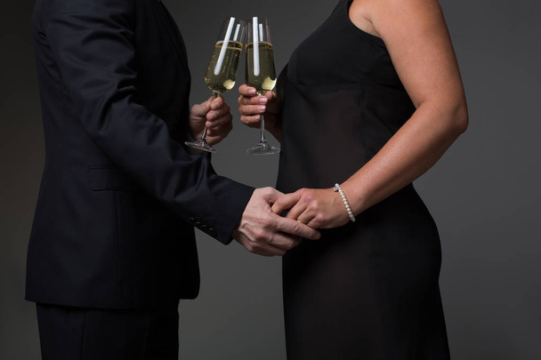 Affectionate man and woman clinking champagne glasses - Foto, immagini