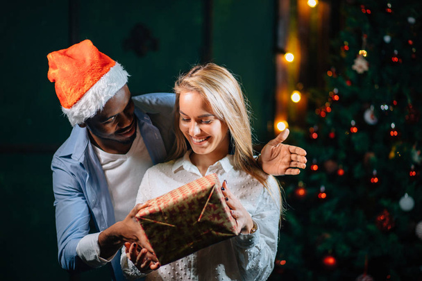 Man giving Christmas present to his girlfriend - Fotografie, Obrázek