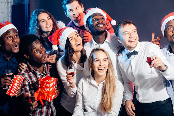 Group of beautiful young people in Santa hats looking a side - Photo, image