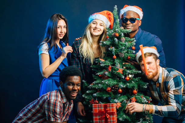 friends makes fun on Christmas holyday with christmas tree - Valokuva, kuva