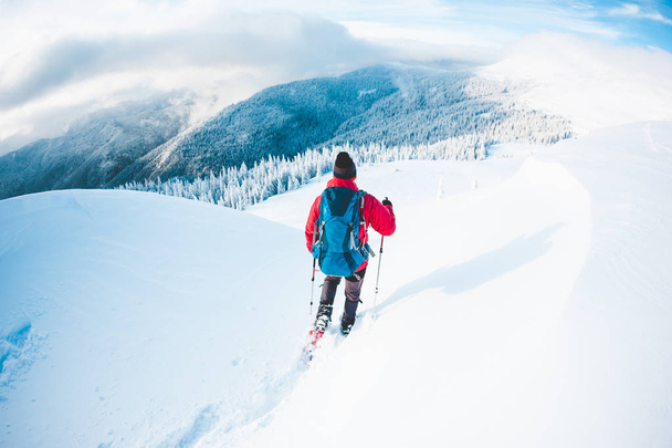 Um homem de sapatos de neve nas montanhas no inverno
.  - Foto, Imagem