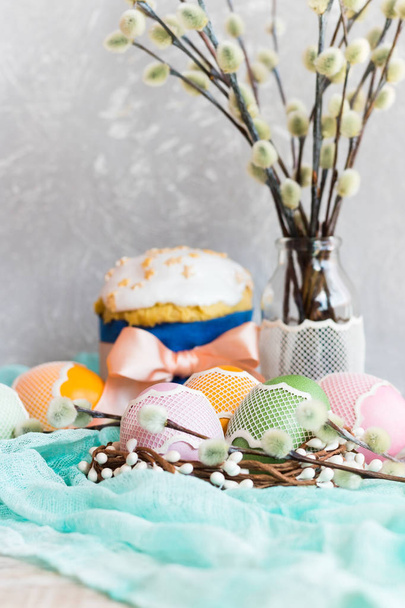 Easter cake with white icing and Easter eggs on a light background - 写真・画像