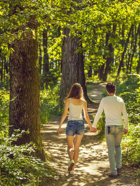 young couple walking in forest - Valokuva, kuva