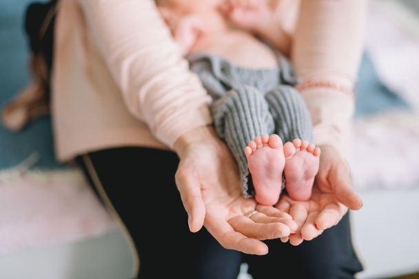 Babys foot in mother hands - Photo, image