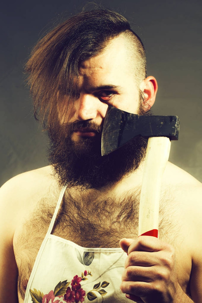 Man in housewife apron with axe - Фото, изображение