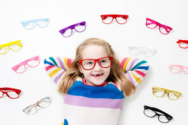 Child at eye sight test. Kid at optitian. Eyewear for kids. - Photo, Image