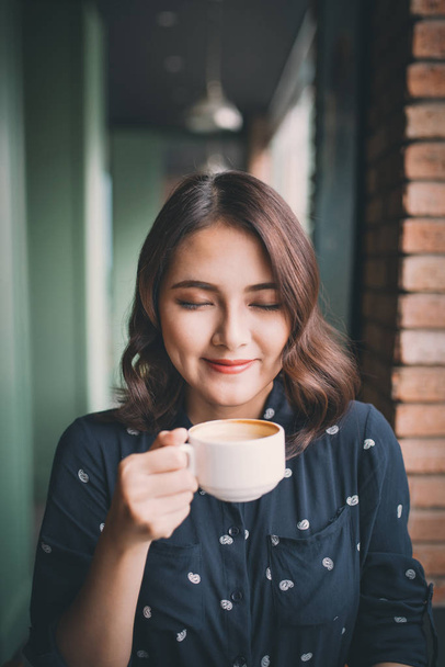 young woman drinking coffee - 写真・画像