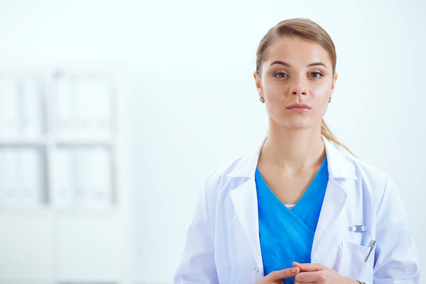 Attractive female doctor in front of medical group. - Photo, Image