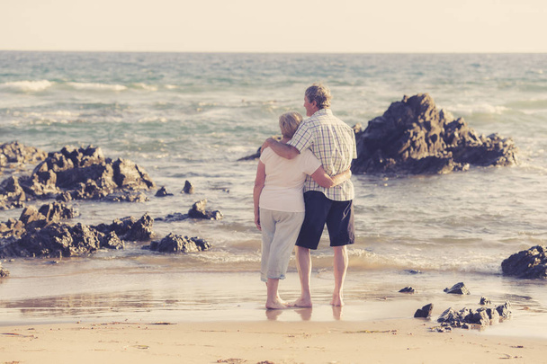 krásná starší zralý pár na jejich 60s nebo 70 let v důchodu chůzi šťastná a uvolněná na pláži mořského pobřeží v romantické stárnutí spolu  - Fotografie, Obrázek