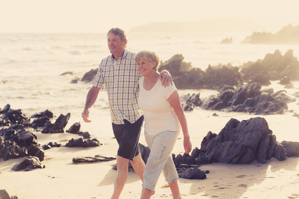 encantadora pareja adulta de edad avanzada en sus 60 o 70 años se retiró caminando feliz y relajado en la playa orilla del mar en el envejecimiento romántico juntos
  - Foto, imagen
