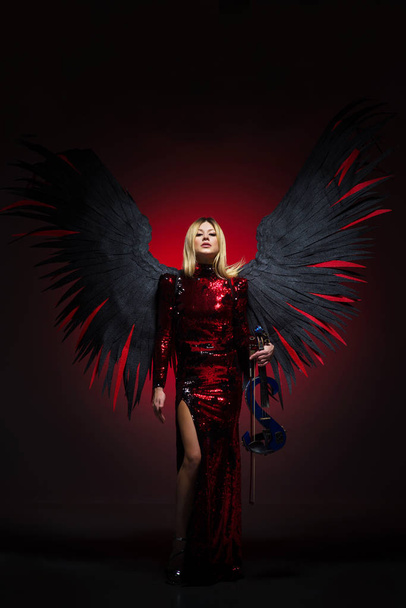 Female with big angel wings on black background. - Photo, Image