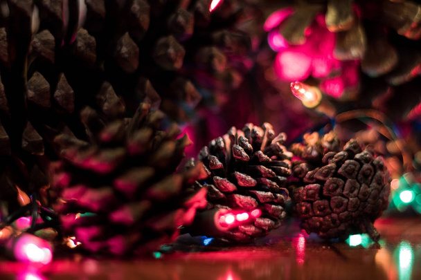 Ananas de navidad. Bajo el arbol de navidad algunos de los bonitos objetos que decoran en estas fechas son las pinias, muchas veces pintadas de colores dorado o plateado. Son sencillos detalles que cambian el concepto de la Navidad
. - Foto, immagini