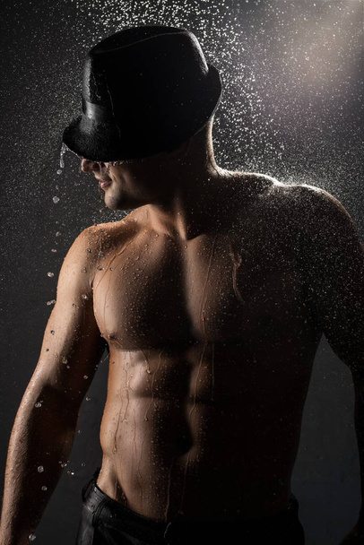 Shirtless young handsome man in shower portrait - Photo, image