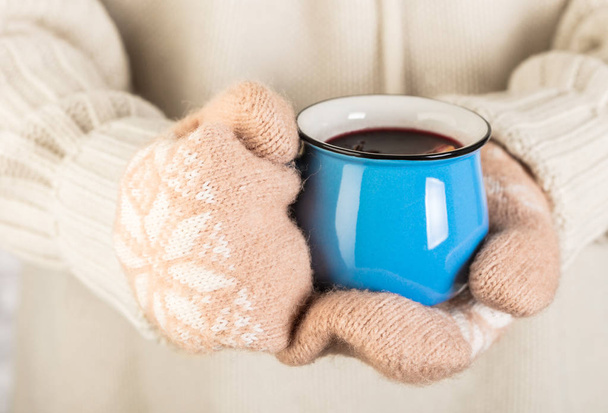 hands in mittens holding a mug of mulled wine - Photo, Image