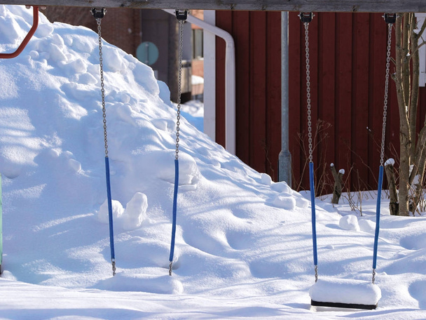 Swings covered with snow as outdoor facility Rovaniemi - Photo, Image