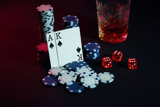 Cards of poker player. On the table are chips and a glass of cocktail with whiskey. Cards - Ace and King - Foto, Bild