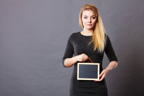 Woman holding blank black board on stomach - Foto, Imagem