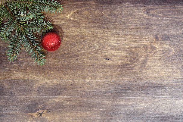 New Years background. Spruce branches on a wooden table. Orname - Фото, изображение