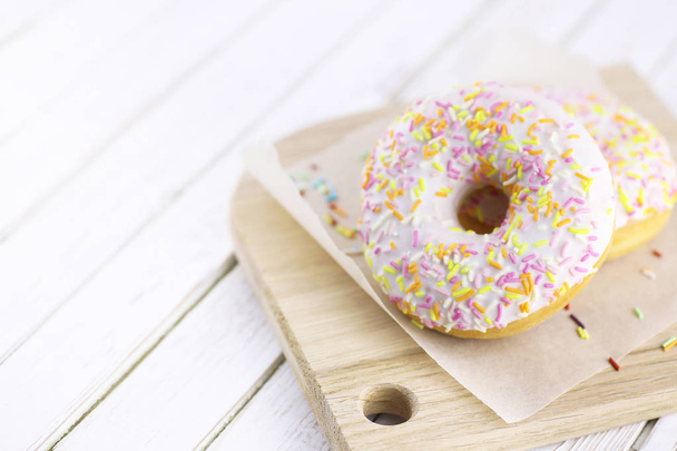 Donut on a wooden white background - Φωτογραφία, εικόνα
