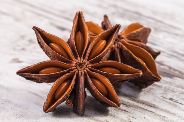 Stars of dried anise (Illicium verum)  on wooden plank, close up - Photo, Image