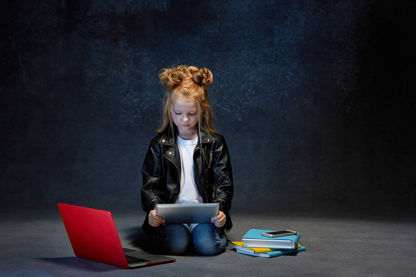 Little girl sitting with gadgets - 写真・画像