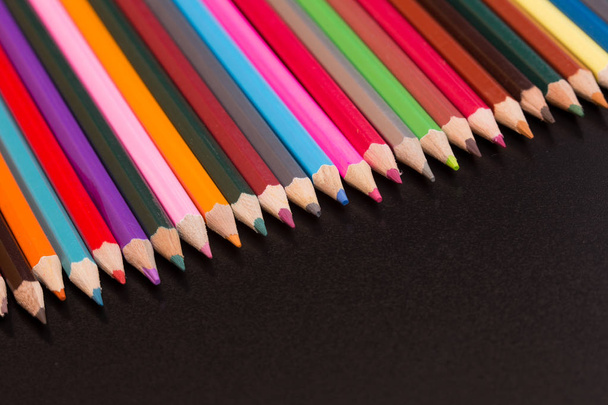 Wooden colorful pencils, on a dark background - 写真・画像