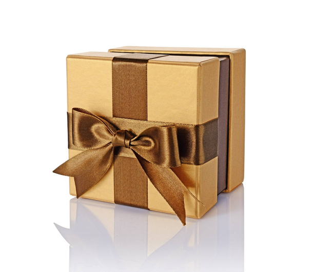 Golden classic shiny gift box with brown satin bow - Foto, Imagen