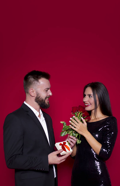 My love is for you. Beautiful young couple in love on a red background. Valentine's Day. Women's Day. March 8 - Zdjęcie, obraz