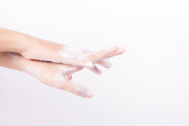 Asian girl hands are washing with soap bubbles on white background - Φωτογραφία, εικόνα